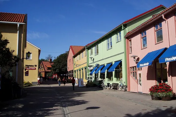 Stora Gatan i Sigtuna med färgglada trähus och butiker en solig dag